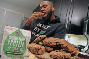 Najee Kelley holding Cranberry-Walnut-Chocolate Chip Protein Cookies